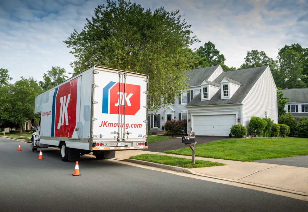 JK Moving residential truck parked in front of house