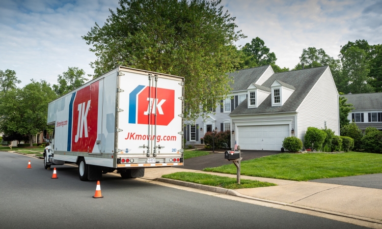 JK Moving residential truck parked in front of house