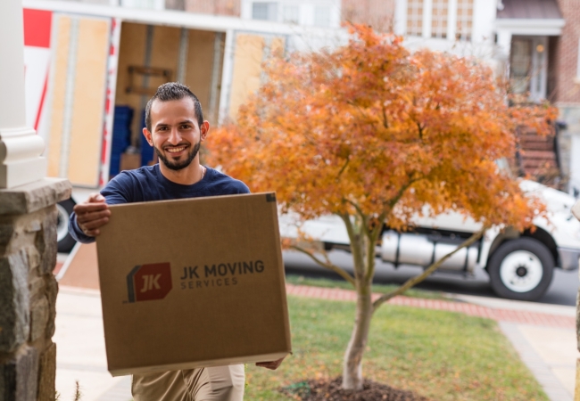 Experienced mover expertly handling a box during a seamless home relocation.