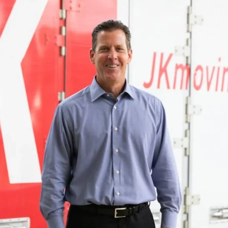 JK Moving CEO Chuck Kuhn standing in front of JK truck