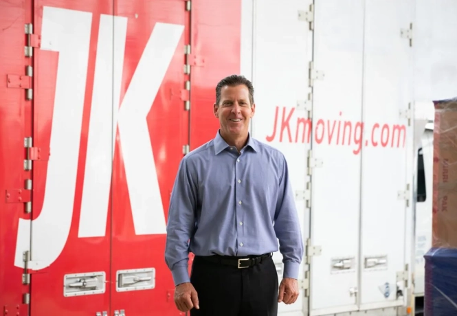 JK Moving CEO Chuck Kuhn standing in front of JK truck