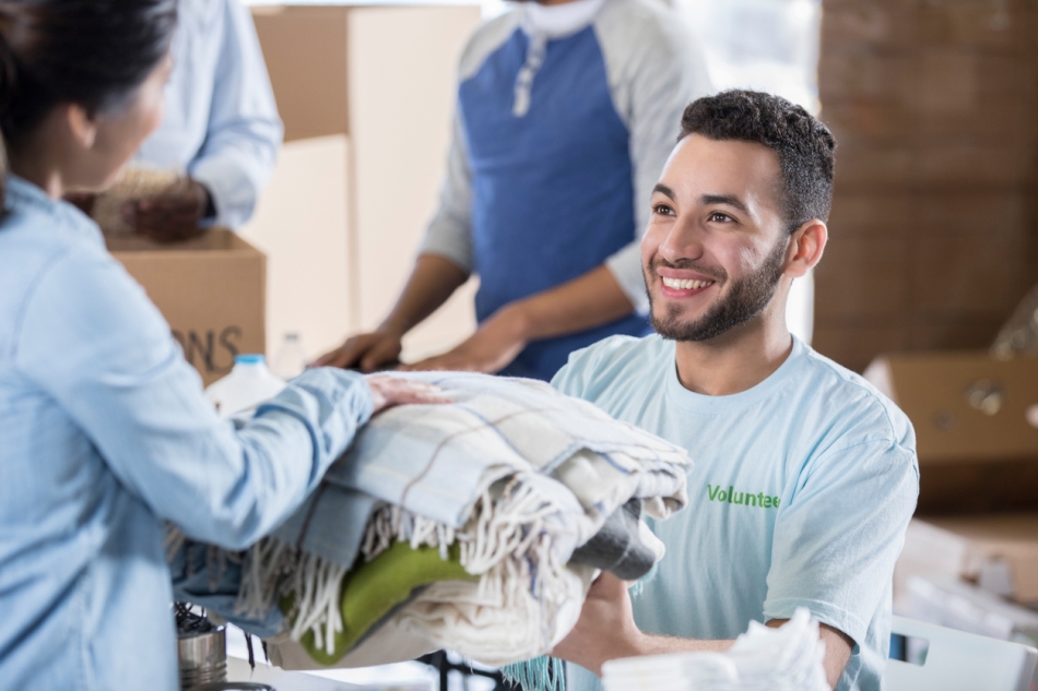 Volunteer receiving clothing donation