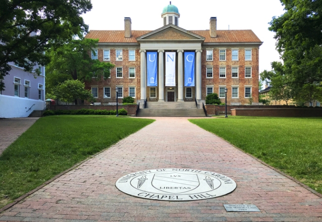 The South Building at The University of North Carolina at Chapel Hill in Chapel Hill, North Carolina is adorned with banners for graduation day