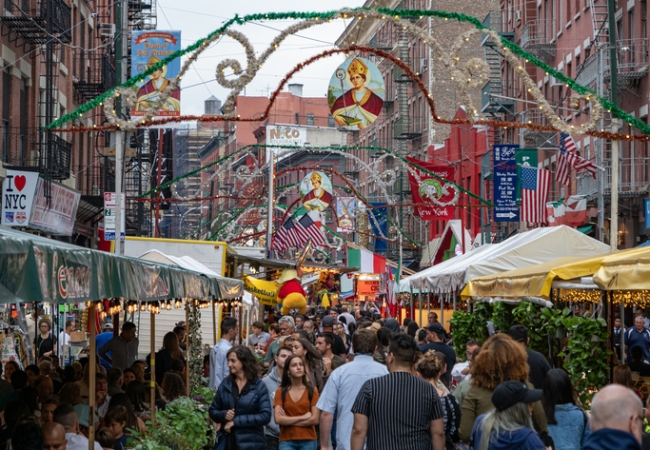 Crowds gather in Mulberry Street to celebrate San Gennaro, New York. The Feast of San Gennaro, an Italian-American festival held annually in September in the Little Italy since 1926., nyc. usa.