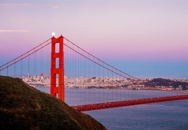 Iconic view of the Golden Gate Bridge with San Francisco's skyline in the background, highlighting the city's blend of tech and arts