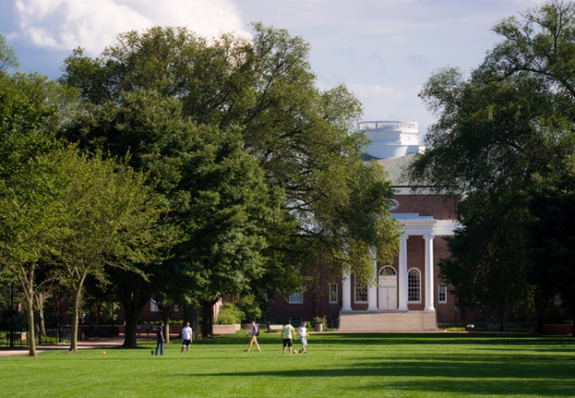 People walk about the grounds of the University of Delaware campus with Memorial Hall in the distance. The university was founded in 1743 and has over 17,000 undergraduate students.